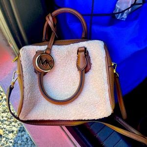 This is a michael kors bag it’s very fuzzy on the outside and comfortable.